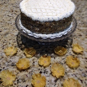 Carrot Cake with whipped cream frosting with pineapple flowers